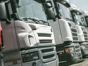 The fronts of three euro truck lorries lined up close to the camera.