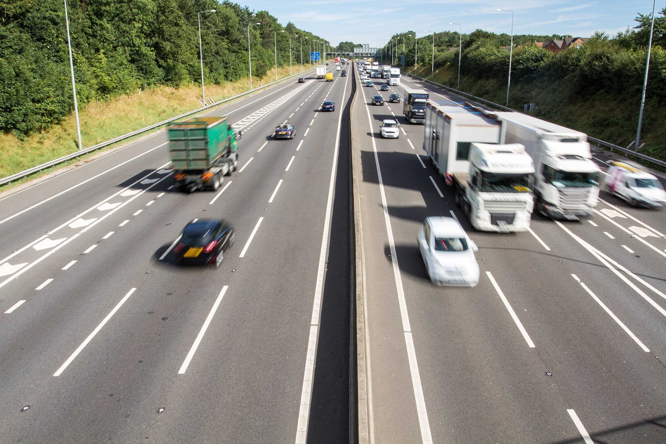 A photograph of traffic including several lorries driving along a UK motorway